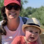 Mom holding toddler both wearing hats