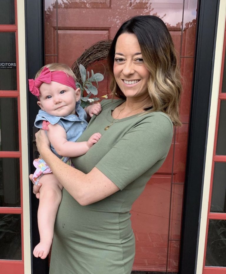 Pregnant Mom holding happy well rested baby overland park kansas