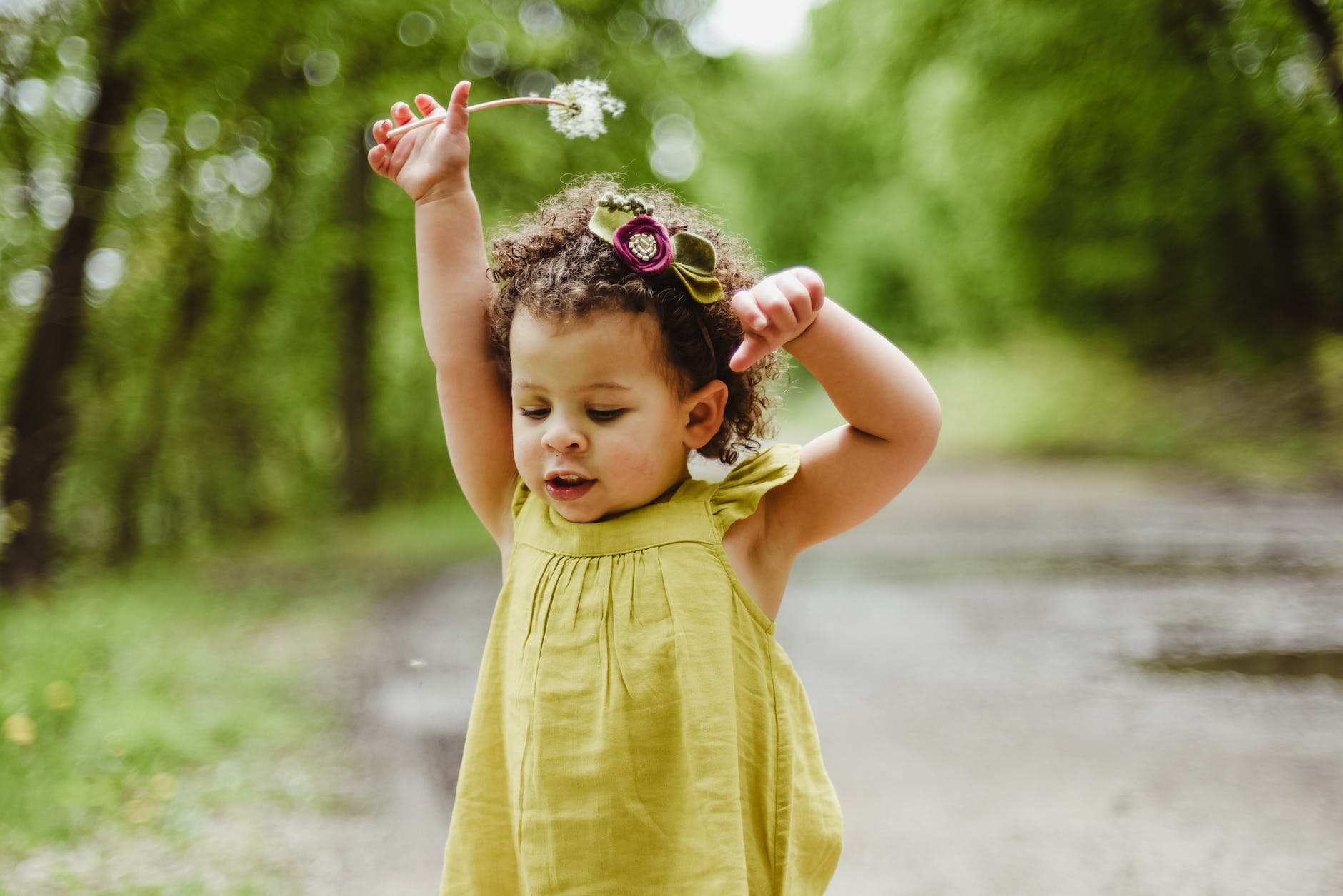 baby wearing green dress o